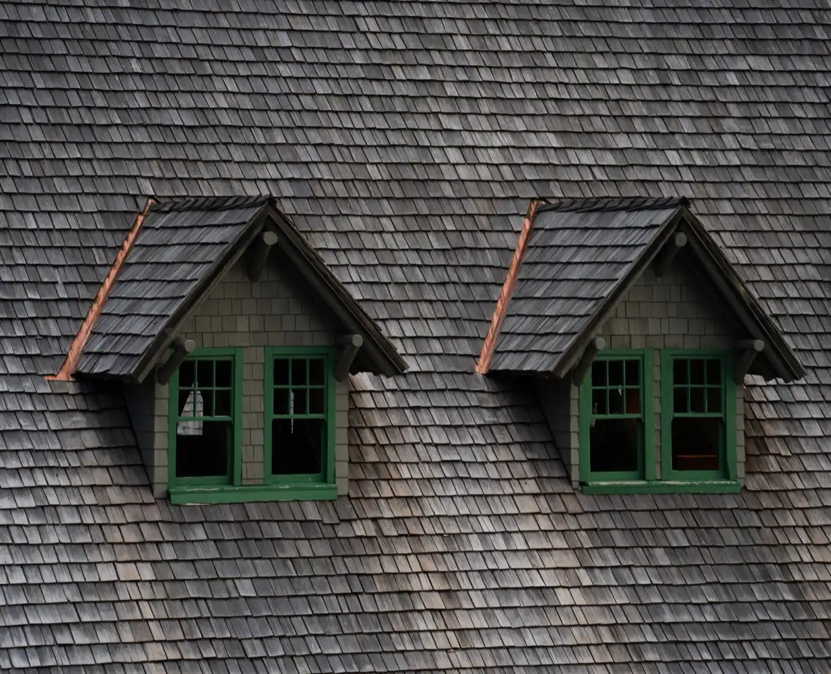 Dormers on a shingle roof in Waco, TX, where step flashing and kickout flashing carry water past the walls